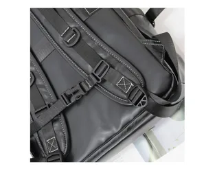 Close-up detail of the black backpack adjustable shoulder straps and durable buckles design.