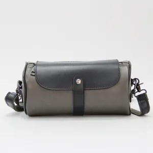 Men's casual cylindrical shoulder bag with contrasting flap, stylish streetwear messenger design.