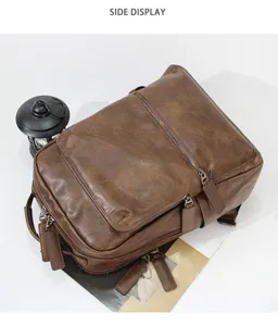 Detailed view of the vintage brown leather backpack with multiple zipper pockets and compartments.