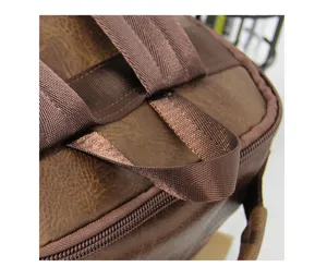 Close-up detail shot of a vintage brown men backpack showing durable straps and zipper design.