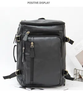 Detail view of the black leather multi-functional travel backpack with multiple zippered pockets.