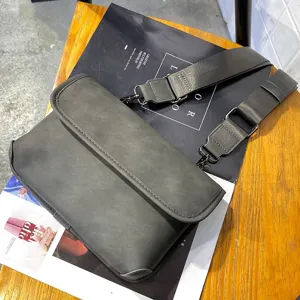 Men's dark grey messenger bag with flap closure and adjustable wide shoulder strap for daily use.