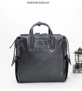 Detailed view of black multi-functional backpack with white contrast stitching and side pockets.