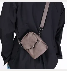 Detailed view of the casual solid color vertical crossbody phone bag for men, stylish design.