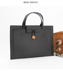 Detailed view of black slim 13 inch laptop handbag with wooden button and dual handles.