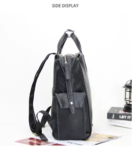 Men leather backpack side detail view, minimalist business laptop bag with top handle.