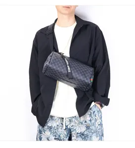 Detailed view of men cylinder crossbody bag, stylish street sling bag with adjustable strap.