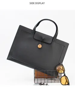 Detailed view of the slim 13 inch black laptop handbag with wooden button and secure storage.