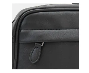 Detalle de bolso bandolera de cuero PU negro que muestra textura fina y cremallera.