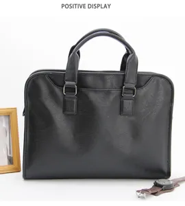 Vista dettagliata della borsa da lavoro in vera pelle nera, con manici e accessori.