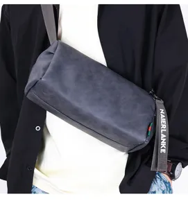 Detailed shot of the stylish cylinder crossbody sling bag worn by model, showing texture.