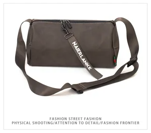 Men gray cylindrical crossbody shoulder bag detail view, casual street style design with strap.