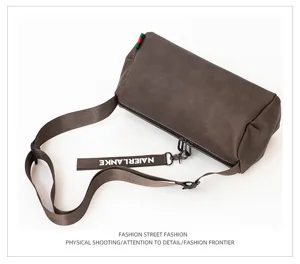 Men stylish cylindrical crossbody bag with adjustable shoulder strap and chic design.