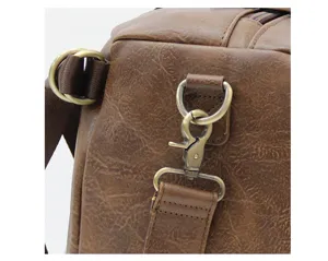 Detailed view of retro brown PU leather men messenger bag shoulder strap metal hardware.