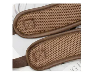 Close up of retro backpack shoulder straps with breathable mesh and brown leather trim.