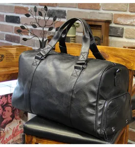 Detail shot of the black travel duffel bag showcasing side shoe compartment and spacious interior.