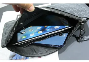 Detail view of men large capacity clutch bag interior showing spacious storage for tablet phone.