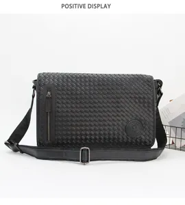 Detailed view of a black woven leather men's messenger bag with a front zip pocket.