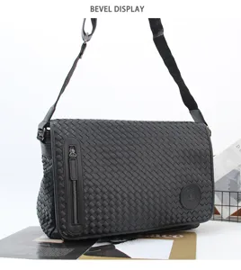 Detailed view of black woven leather messenger bag, adjustable strap and front zipper pocket.