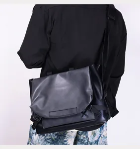 Detail view of the mens leather messenger bag showing adjustable strap and flap closure.