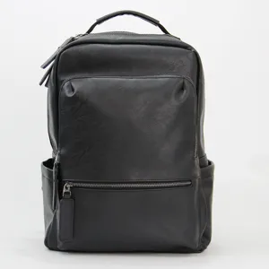 Classic black leather backpack for men, casual business computer bag with spacious compartments.