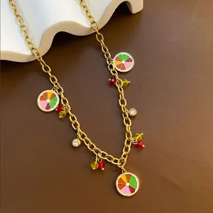Gold titanium steel chain necklace with colorful enamel fruit slice pendants and crystals detail.