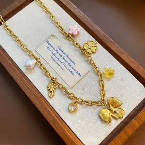 Chic gold titanium steel necklace featuring pearl and bow pendant charms for women daily.