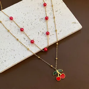 Exquisite titanium steel double layer necklace with red cherry pendant and sweet pearl beads design.