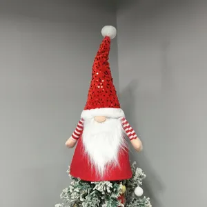 Christmas gnome tree topper close-up, plush faceless doll with red sequin hat and white beard.