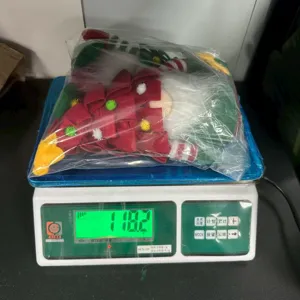 Christmas tree gnome plush doll weighing detail shot showing net product weight clearly.