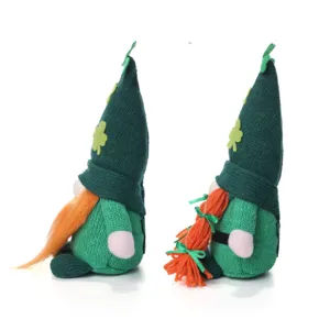 Detail view of Saint Patrick's Day gnome plush toys with green knitted hats and orange braids.
