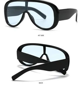 Detailed view of oversized shield sunglasses with light blue lenses and thick black frames.