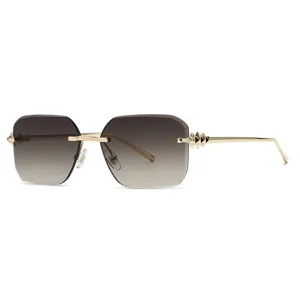 Lunettes de soleil carrées sans monture avec verres dégradés et branches dorées à clous.
