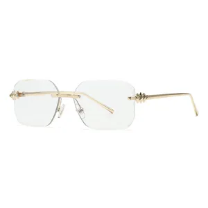 Lunettes de soleil carrées sans monture femme, monture métal doré chic avec clous élégants.