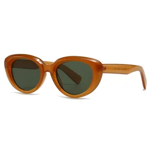 Chunky cat-eye sunglasses for women and men, stylish amber frame with dark green lenses.