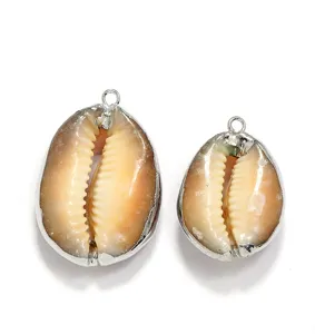 Natural cowrie shell pendants with electroplated silver edges, perfect for DIY jewelry making.
