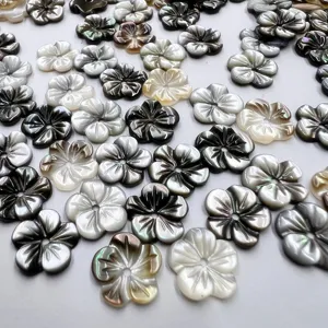 Detailed view of black mother of pearl carved flower beads, ideal for DIY jewelry crafts.