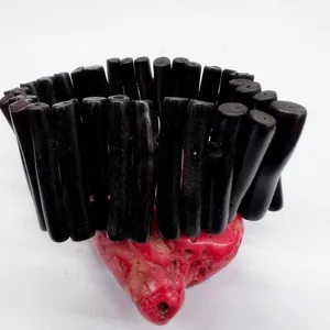 Close-up detail of wide black coral branch stretch bracelet showing unique texture.