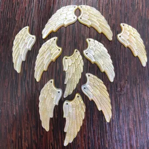 Natural seashell carved wing pendants for DIY handmade jewelry crafting and design.