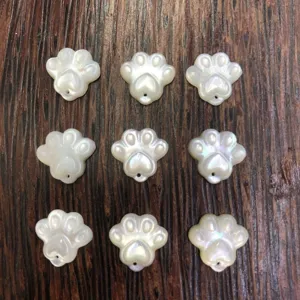 Delicate mother-of-pearl paw pendants, perfect for DIY jewelry making and cute craft projects.