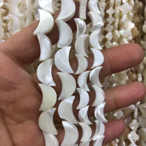 Natural mother of pearl crescent shell beads detail shot for DIY handmade jewelry crafting.