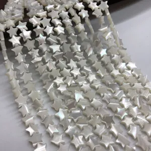 Close-up of natural white mother-of-pearl star beads strand, perfect for DIY jewelry making detail.
