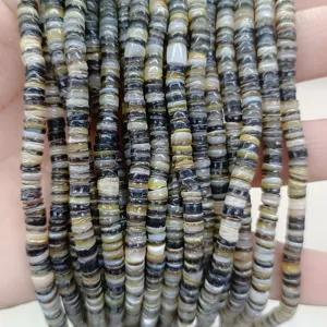 Natural shell spacer beads detail shot, multi-strand round disc DIY jewelry accessory display.
