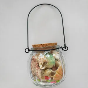 Glass seashell wishing bottle with metal handle and cork lid for DIY beach crafts decor.