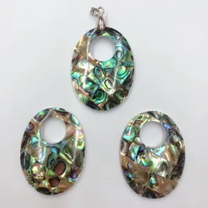 Detailed shot of oval abalone shell mosaic pendant and components with colorful iridescent luster.