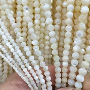 Natural white mother of pearl shell round beads strands detail shot for DIY jewelry making.