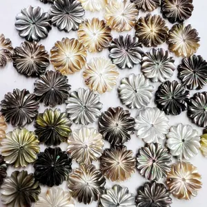 Close-up detail of carved shell flower loose beads with center holes for DIY jewelry making.