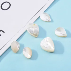 Detailed shot of teardrop shaped natural mother-of-pearl shell DIY jewelry making pieces.