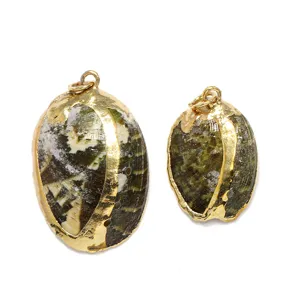 Close-up view of natural abalone shell pendants with gold plated rims and metal rings.