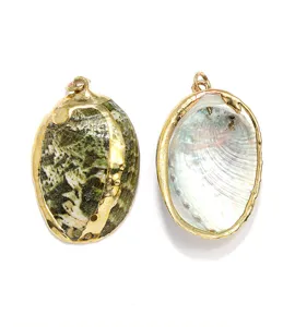 Green abalone shell pendant with gold plated rim natural pearlescent jewelry detail view